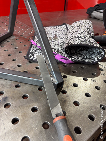 After using an angle grinder to do the rough cleanup, files help give a crisp edge